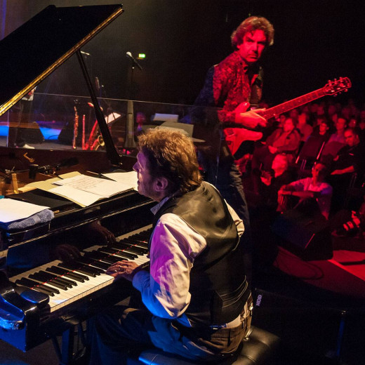 During a very rare Soft Machine gig with guest Keith Tippett I listened to one of Tippett's piano solos from backstage. Suddenly John Etheridge crossed my eyes and I made this shot. Photography is art. Copyright holder for this art work: © Clemens Mitscher / VG Bild-Kunst, Bonn.